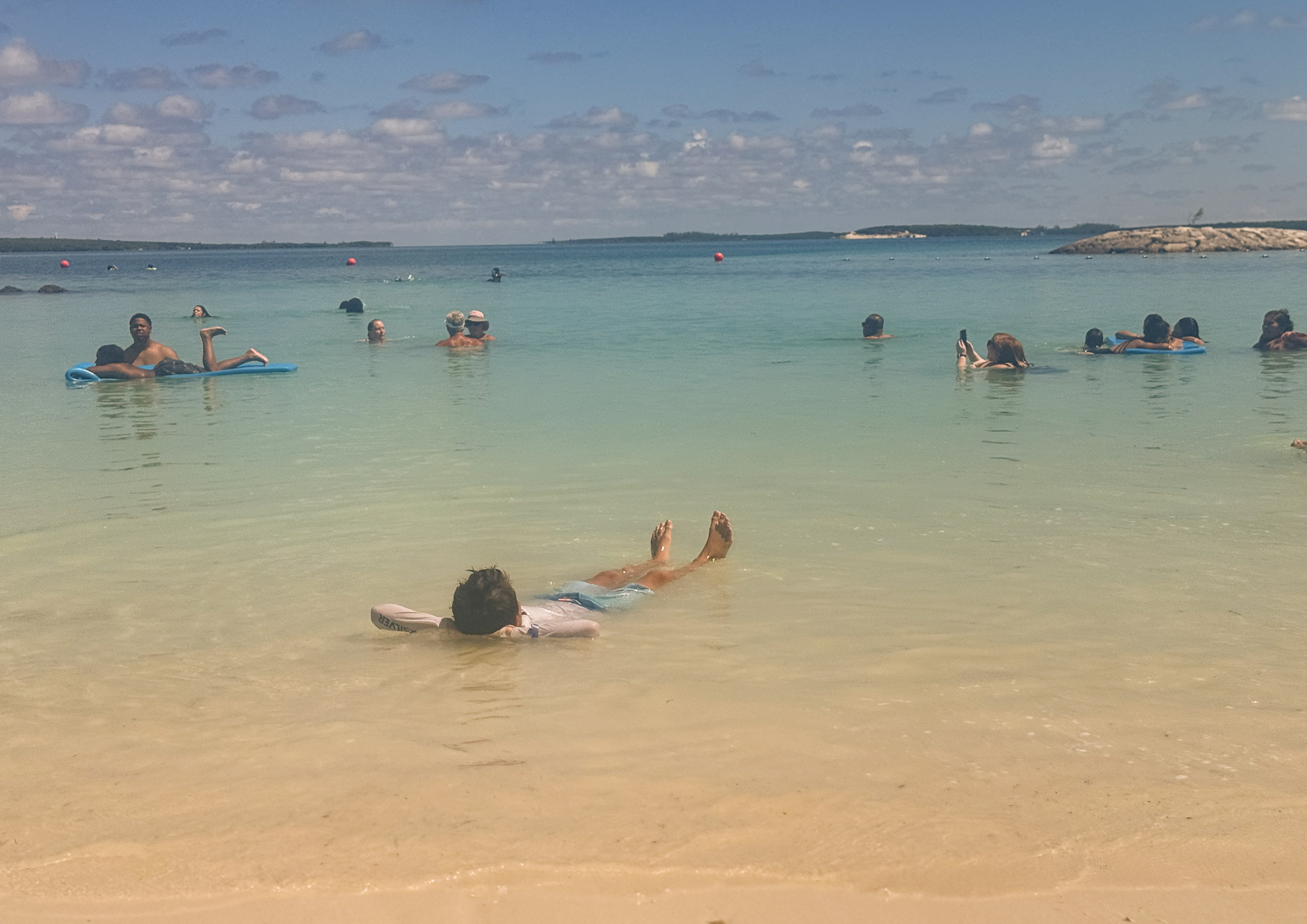 my son floating in the water at Cococay