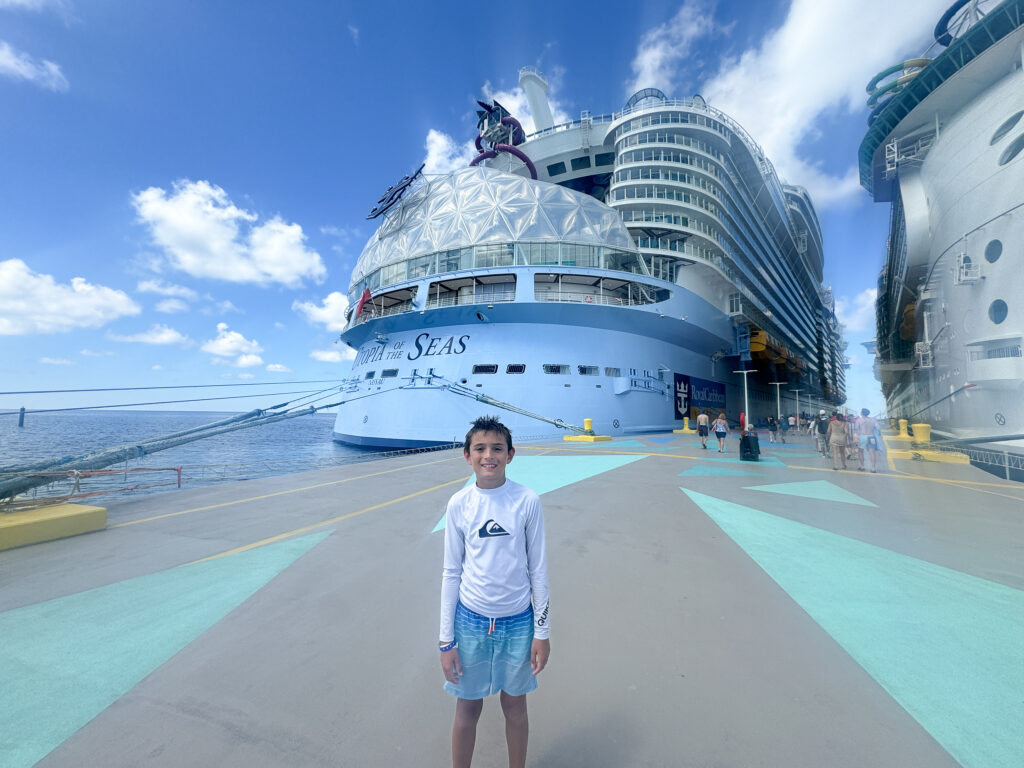 my son in front of Utopia of the Seas