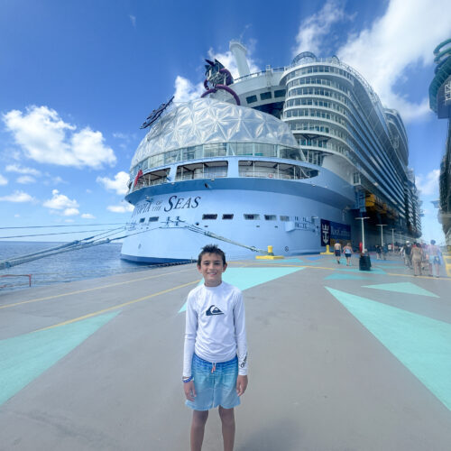 my son in front of Utopia of the Seas