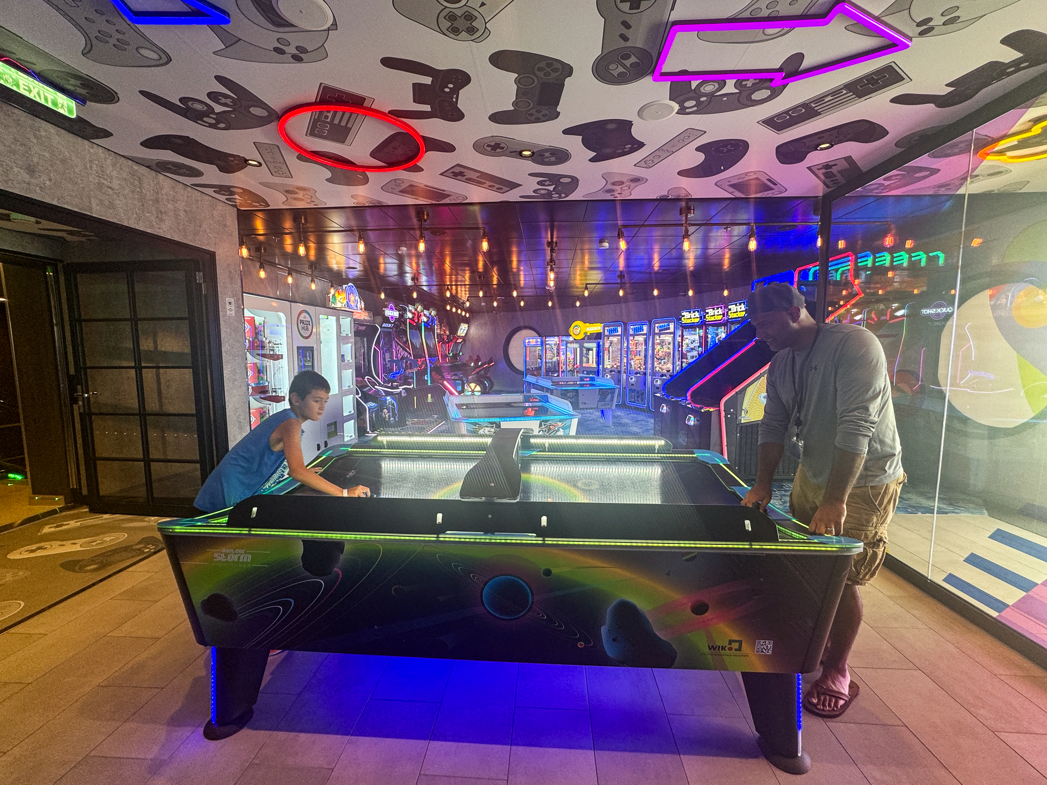 my family playing air hockey in the arcade on Utopia of the Seas