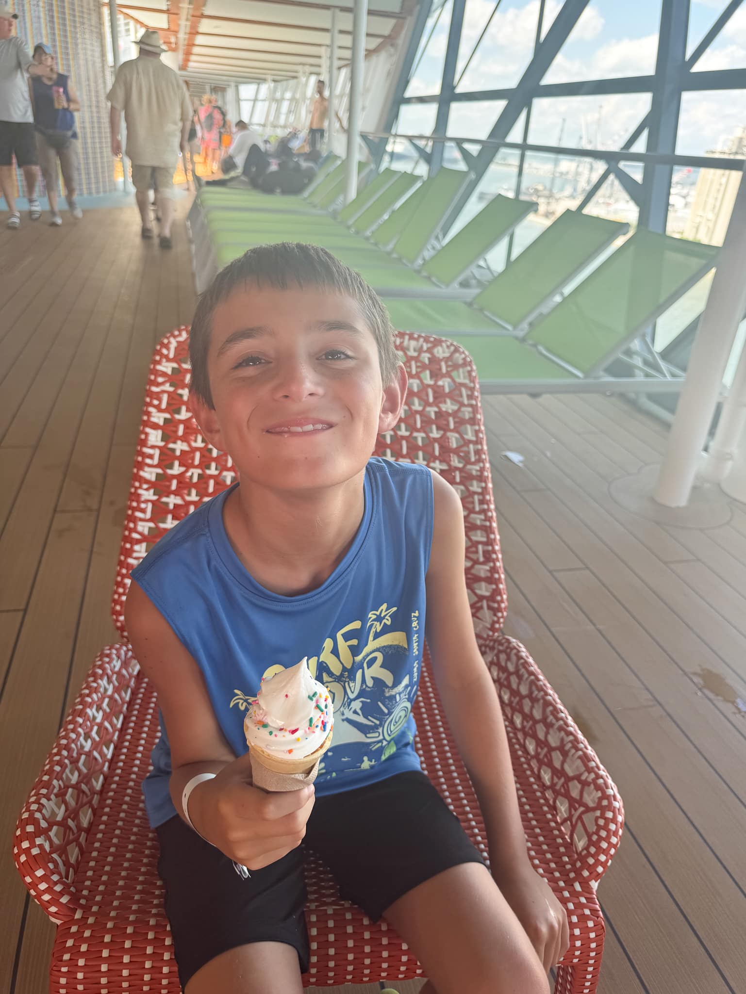 my son eating an ice cream on the pool deck