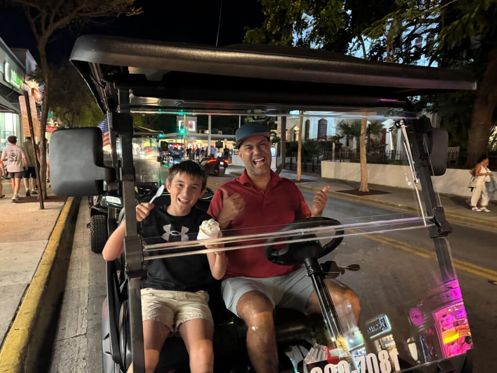 my husband and son on the golf cart in Key West