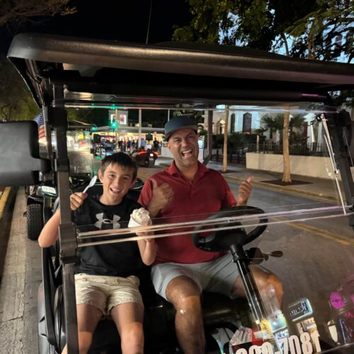 my husband and son on the golf cart in Key West