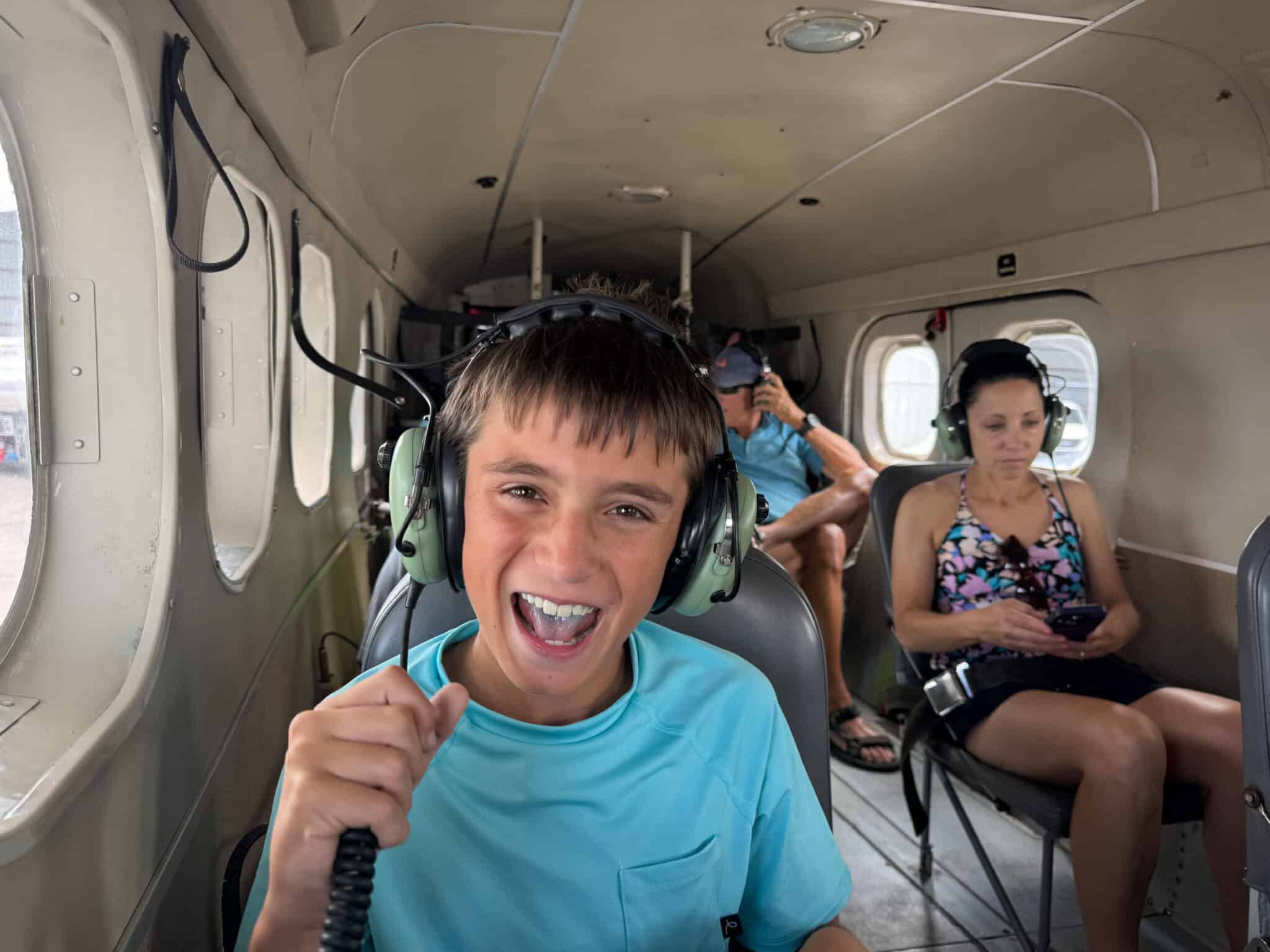 my son in the sea plane with his headset on