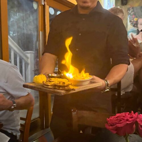 server bringing the flaming saganaki to our table