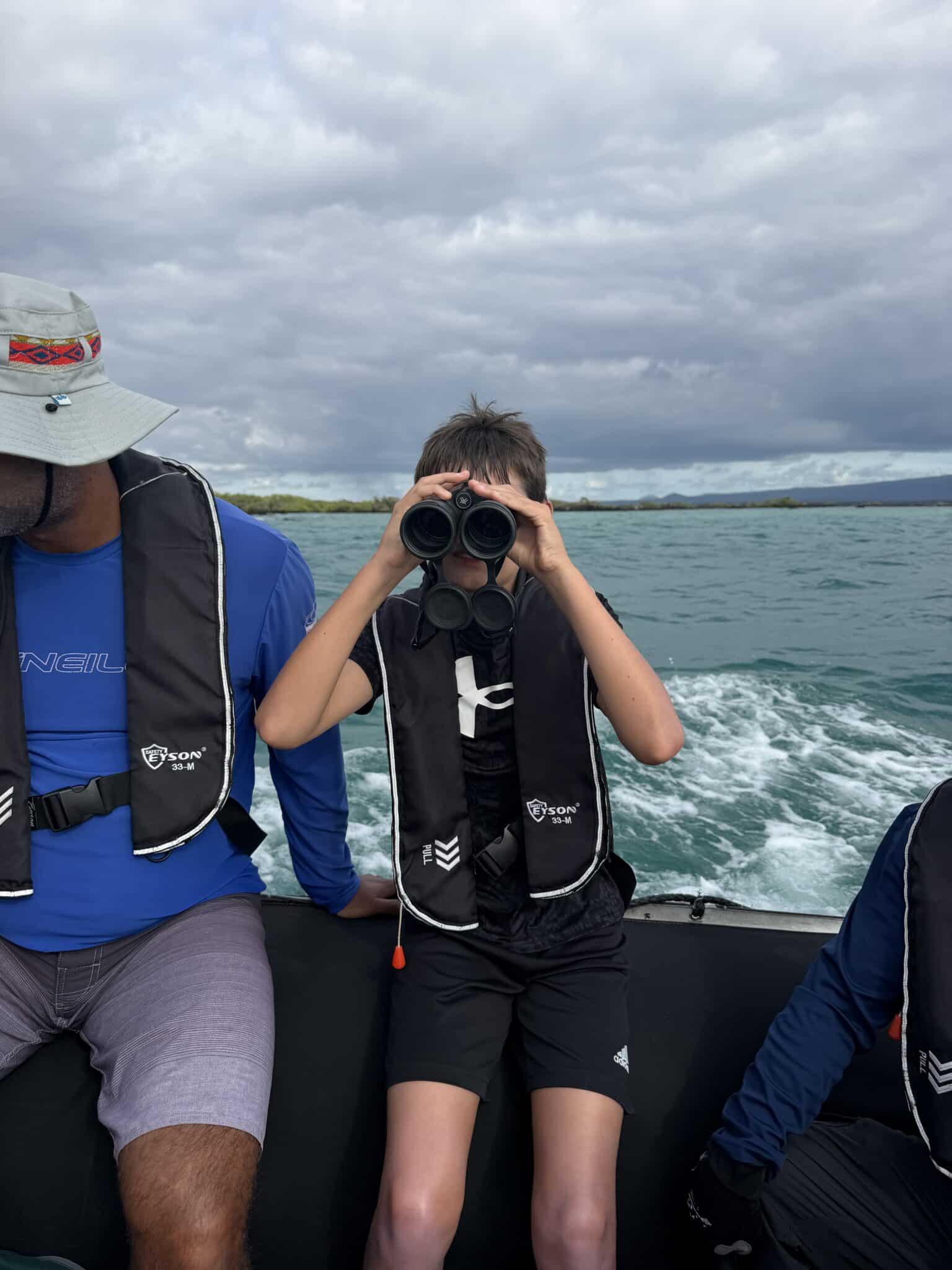 my son with his binoculars on the panga ride