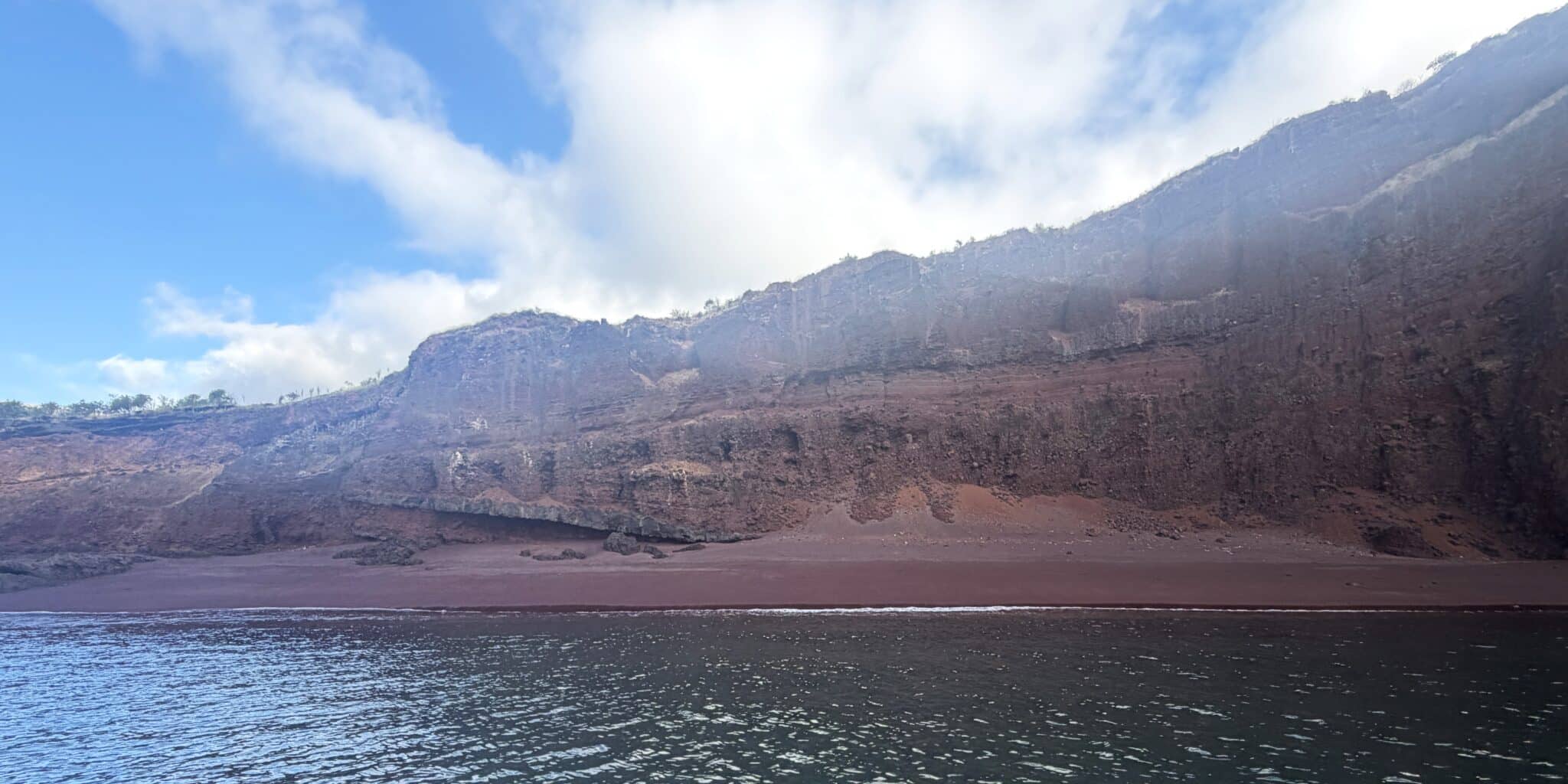 red sand beach on Santiago island in Galapagos