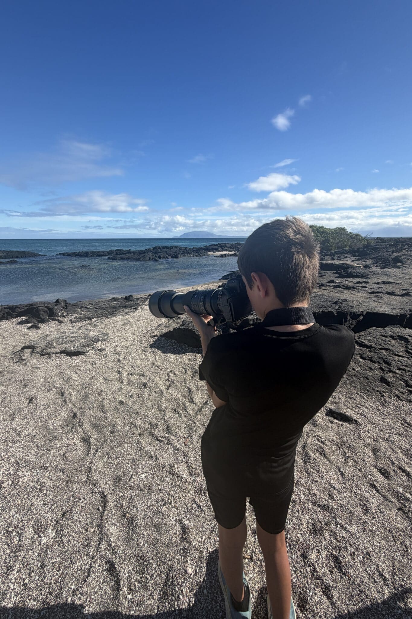 my son taking photos with my camera in the galapagos