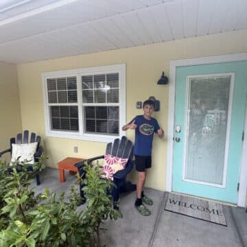 my son on the front porch of our vacation rental at Sand and Sea in Anna Maria