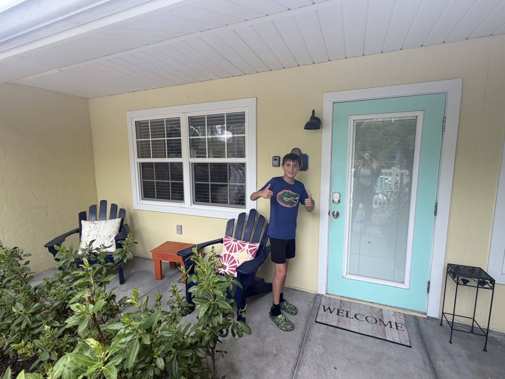 my son on the front porch of our vacation rental at Sand and Sea in Anna Maria