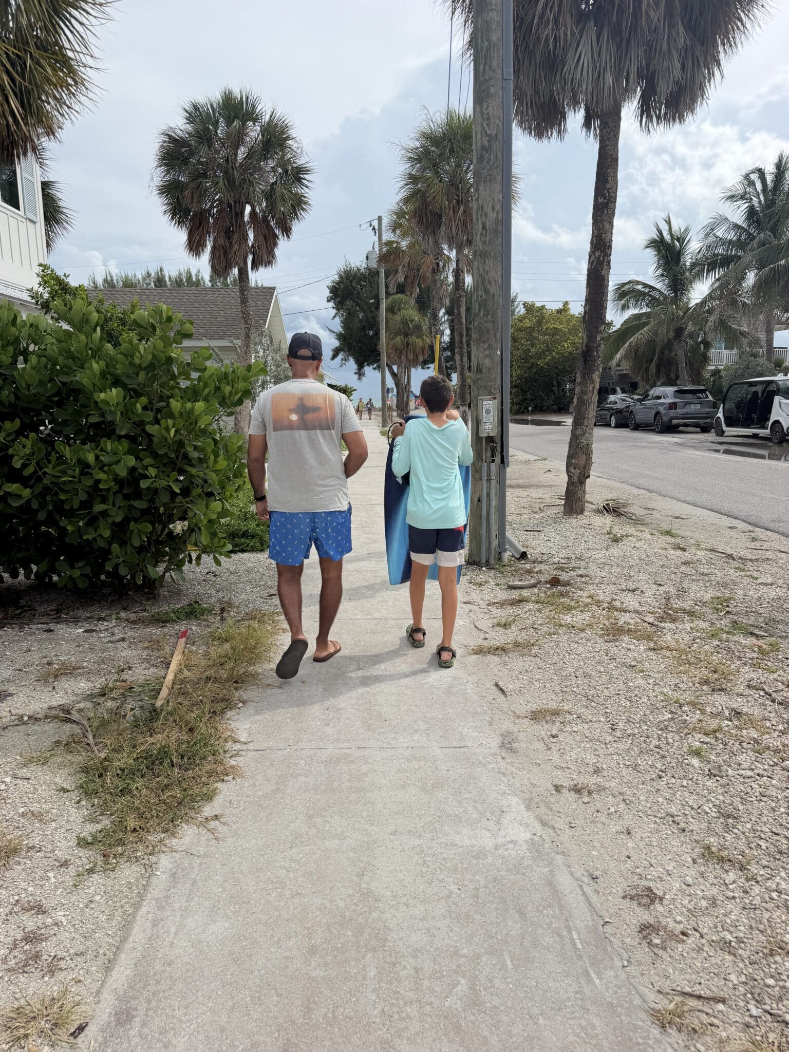 my husband and son walking to the beach from our condo on Anna Maria Island